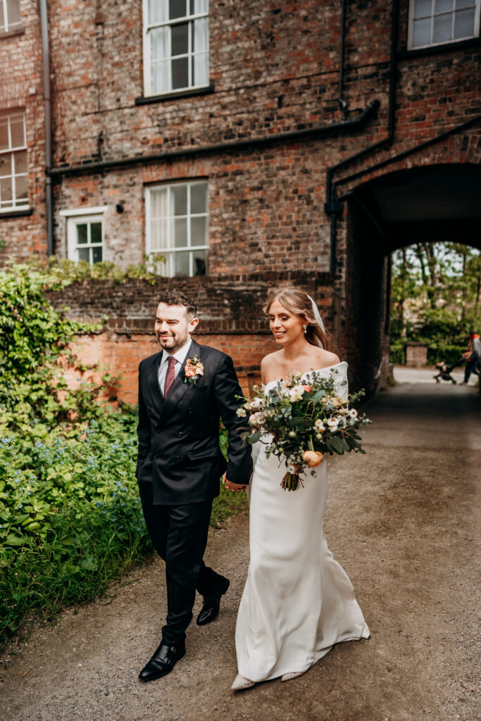 Bride and Groom walking smiling through York street