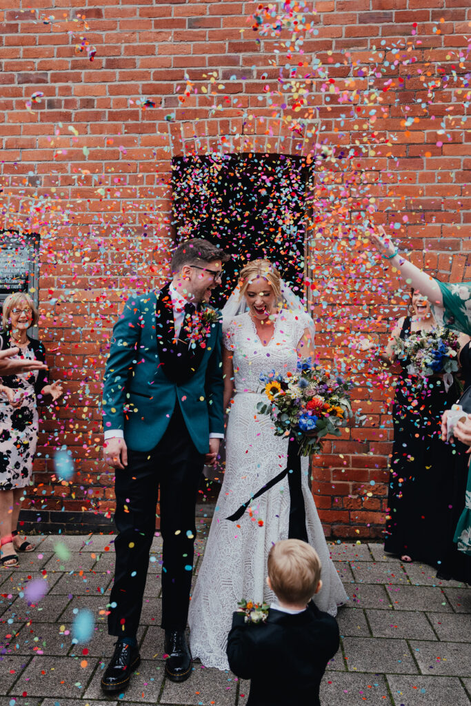 Bride and Groom in colourful confetti at The Chimney House