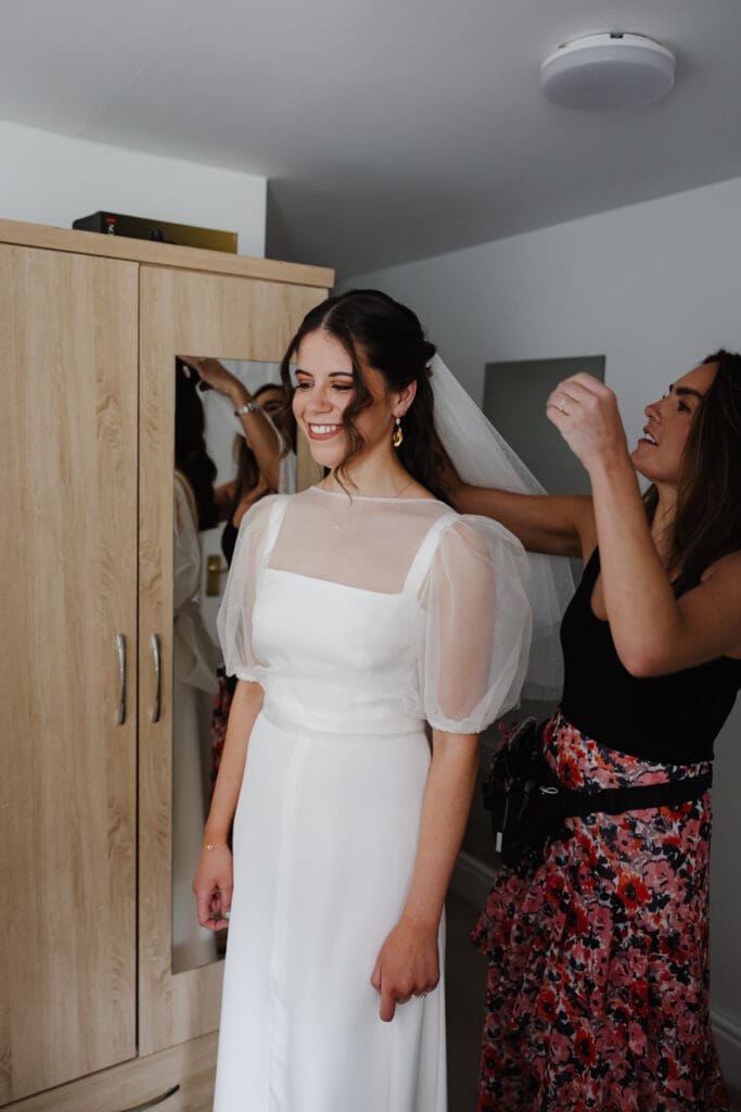 Bride getting veil put in